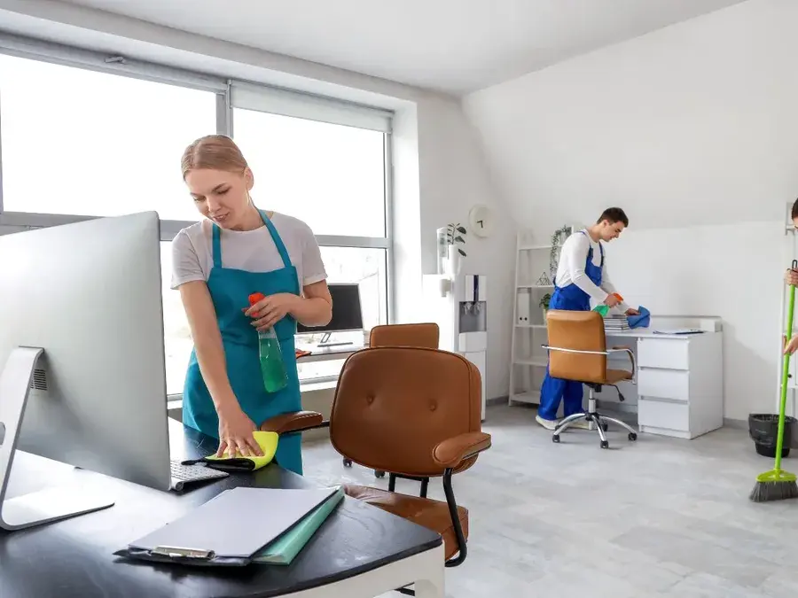 Cleaners wiping desks and sweeping floors in an office in Winter Garden, FL Cleaners wiping desks and sweeping floors in an office in Winter Garden, FL